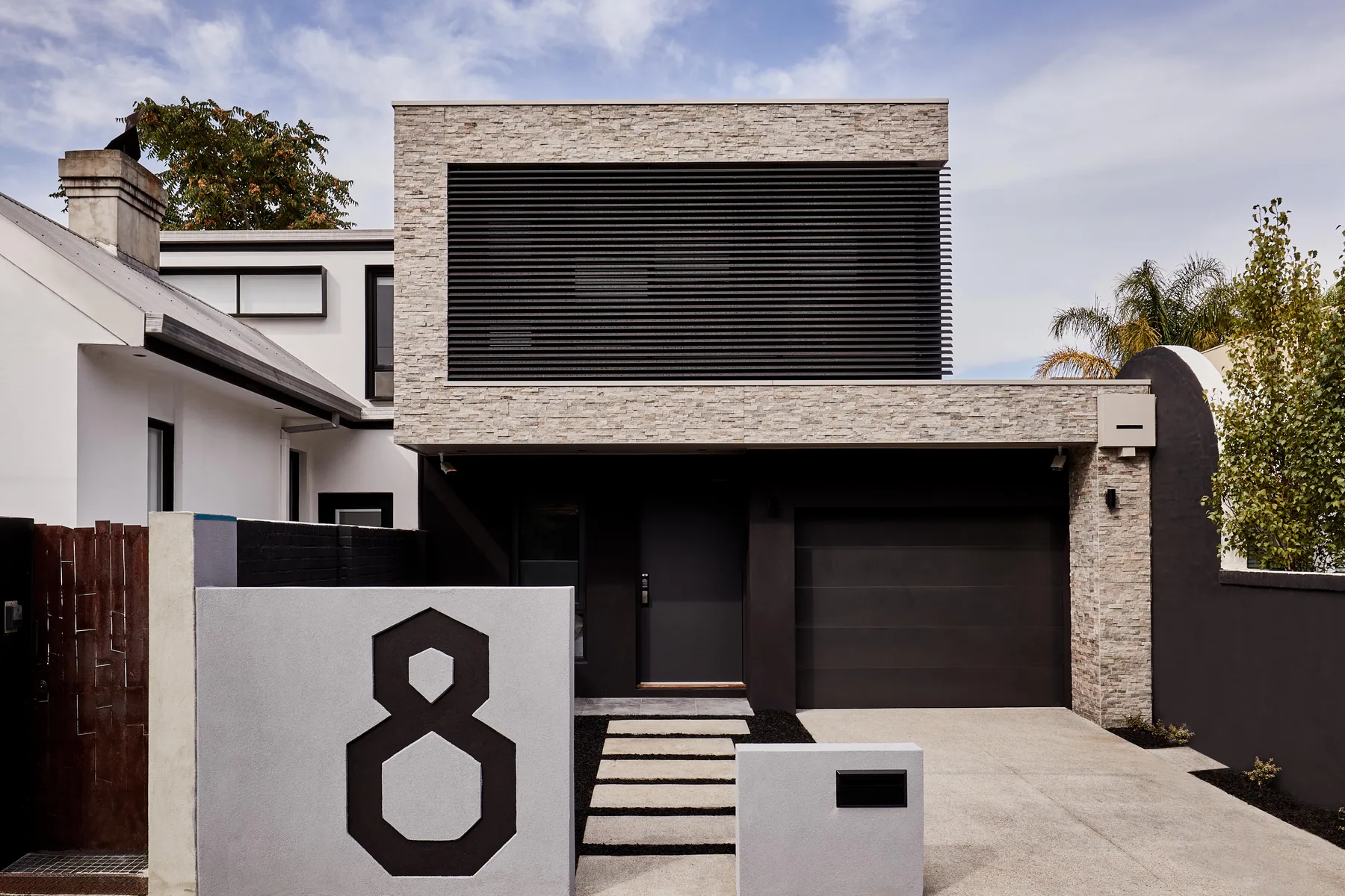 Argo Studio: A compact urban home combining a disciplined street elevation with bright, finely detailed interiors.